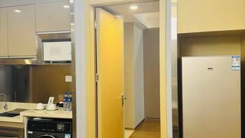 A modern kitchen with a dishwasher, microwave, and a refrigerator.