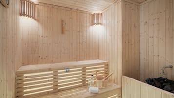 A wooden sauna with a bench, a bucket, a towel, and a water bottle.