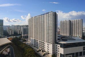 A high-rise hotel with a grid-like facade, multiple balconies, and a prominent sign at the top. - Somerset Haizhu Centre Guangzhou (Guangzhou)