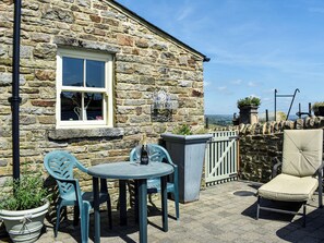 A stone building with a window, a table with chairs, and a view of the countryside. - 2 bedroom accommodation in Westgate, Near Stanhope (Westgate, Near Stanhope)