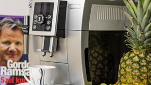 A coffee machine, a pineapple, and several cups on a table. - Cades Accommodation (Wolverhampton)