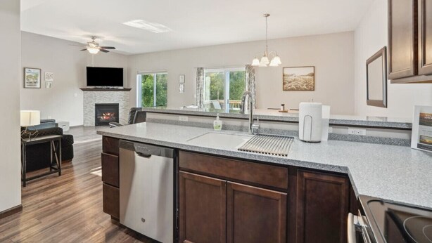 A modern kitchen with a large island, built-in appliances, and a fireplace. - Spacious 4 BR Home Convenient Location (Tiffin)