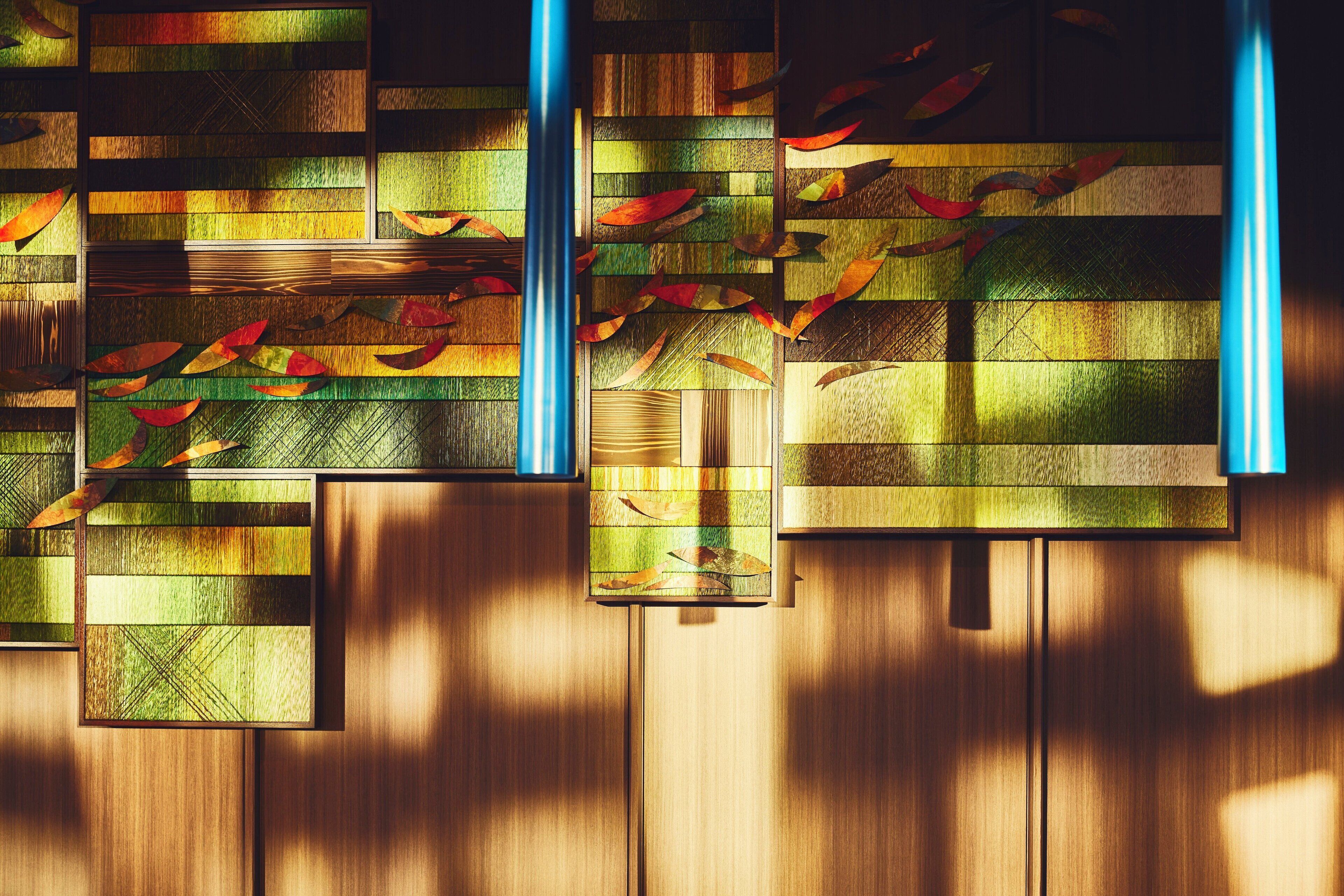 A wall with a geometric pattern and a wooden panel design.