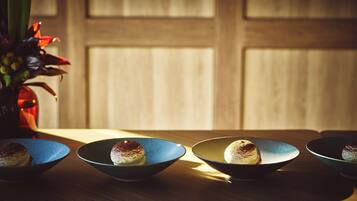 Trois assiettes à dessert sur une table en bois, avec une plante en arrière-plan.