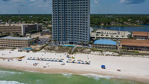 A high-rise hotel with a beach view, multiple floors, and a pool area. - Sterling Breeze 403 - 2180902 (Panama City Beach)
