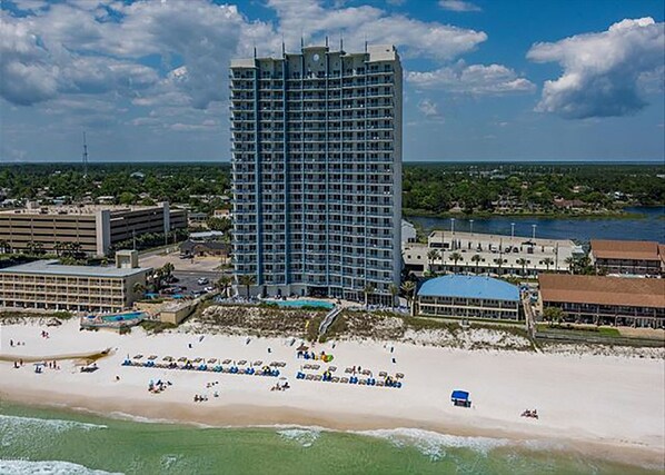 A high-rise hotel with a beach view, multiple floors, and a pool area. - Sterling Breeze 403 - 2180902 (Panama City Beach)