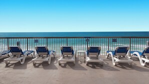 A beachside lounge with sun loungers and a view of the ocean. - Sunrise Resort by BBG (Panama City Beach)