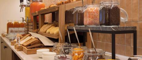 A breakfast buffet with various food items and beverages.