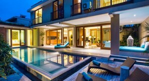 A modern two-story house with a swimming pool, outdoor seating, and a well-lit interior. - Maca Villas Spa Umalas (Kerobokan)