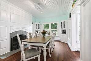 Enjoy meals in this classic dining room with a wooden table and comfortable chairs.