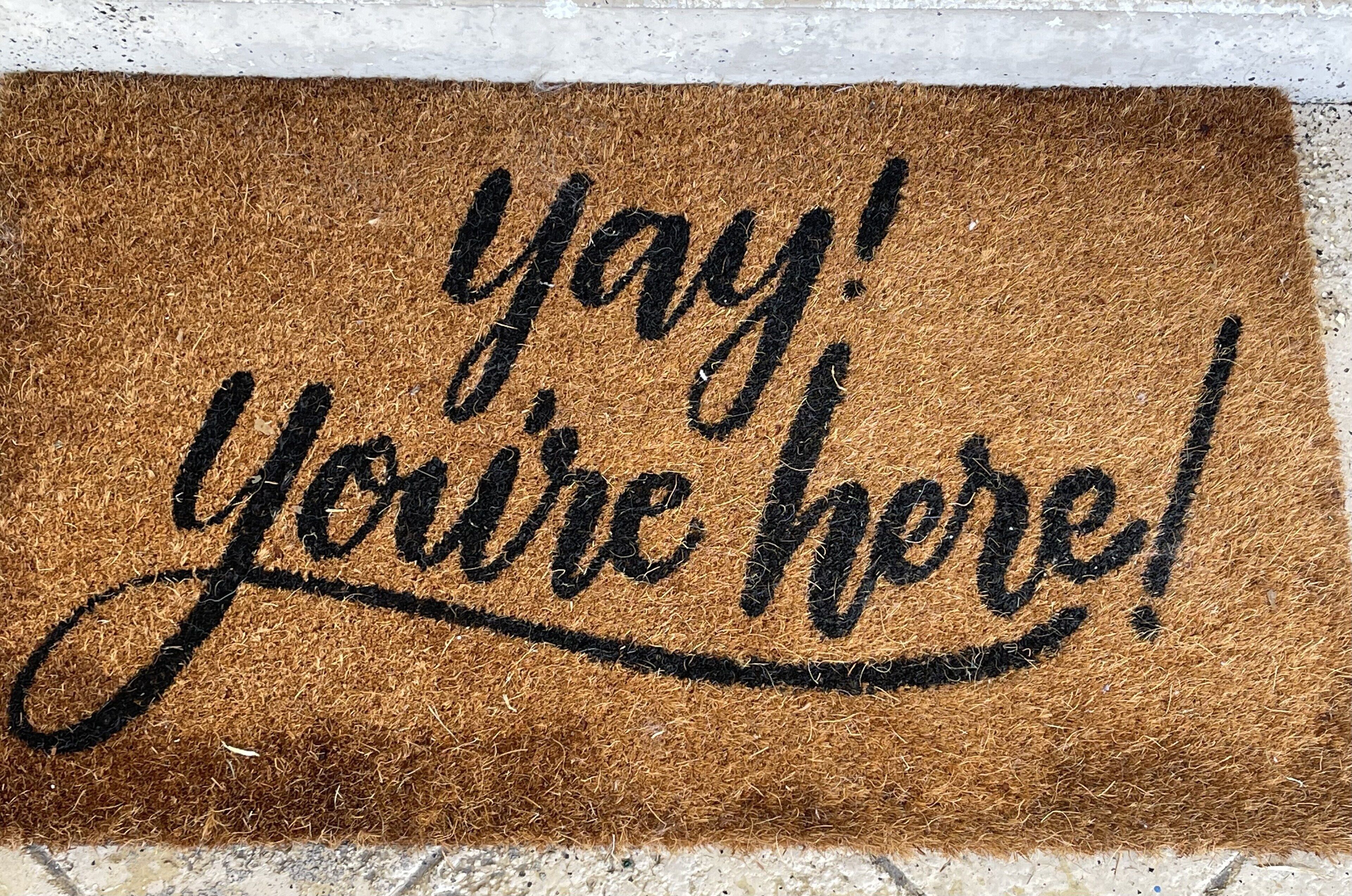 A doormat with the text "yay! You're here!"