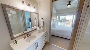 A modern bathroom with a large mirror, a sink, and a vanity.