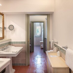 A bathroom with two sinks, a mirror, and a shower area. - Santavenere Hotel (Maratea)