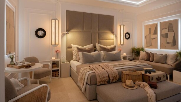 A modern bedroom with a large bed, bedside tables, a sofa, and a small round table with chairs. - Santavenere Hotel (Maratea)