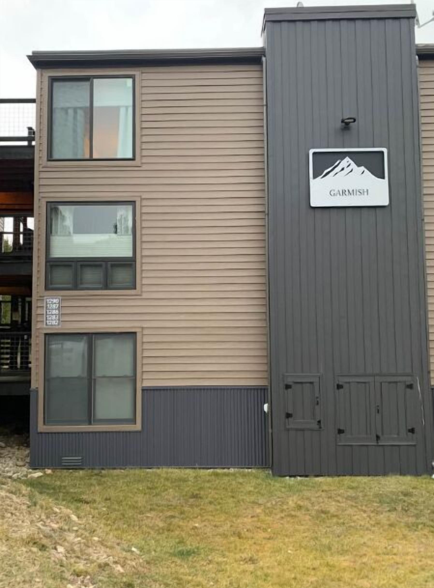 A multi-story building with a sign reading "GARMISH" and a mountain graphic.