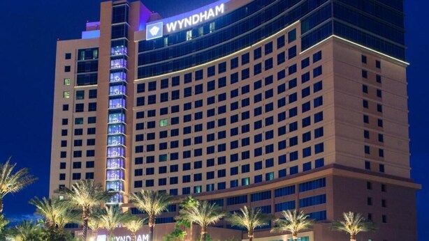 A multi-story hotel with a prominent 'WYNDHAM' sign on the top. - Las Vegas Timeshare at Wyndham Desert Blue (Las Vegas)