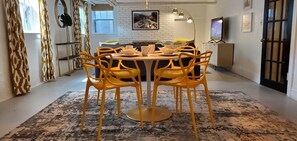 A dining area with a round table, six yellow chairs, and a patterned rug. - Historic Lake Harriet - Garden Level - Quiet Neighborhood. Walk to Lake, Shops. (Minneapolis)