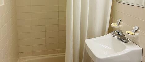A bathroom with a bathtub, a sink, and a toilet.