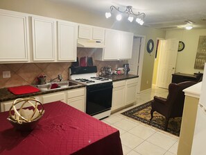 Fridge, microwave, coffee/tea maker, cookware/dishes/utensils