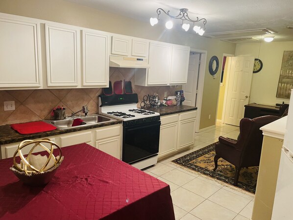 Fridge, microwave, coffee/tea maker, cookware/dishes/utensils