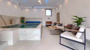 A modern living room with a large pool, comfortable seating, and a minimalist design. - Villa with swimming pool, sauna and indoor pool (Nedešćina)