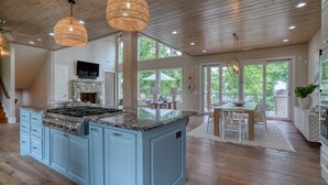 A spacious kitchen with a large island, wooden ceiling, and a dining area with a table and chairs. - Save 15% Off 4 Night Stay! Amazing Waterfall/Lake Views! Pool, Dock! (Vinita)
