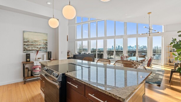 A modern kitchen with a large island, large windows, and a city view. - Nashville Skyline Views - 3BR/3BA, 5 Mins to Downtown (Nashville)