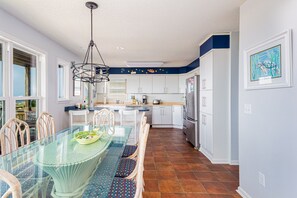 Enjoy cooking in this well-equipped kitchen with a central island, white cabinetry, and stainless steel appliances.