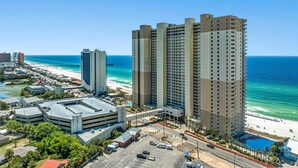 A high-rise hotel with multiple floors, a parking garage, and a beach view. - Tidewater 1413 - 2198668 (Panama City Beach)