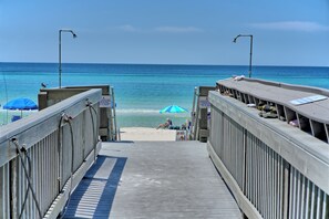 A wooden pier leading to a beach with a clear view of the ocean. - Sunrise Resort by BBG (Panama City Beach)