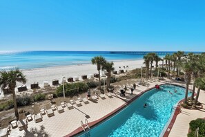 A resort pool area with a view of the beach and ocean, including lounge chairs and a pool. - Calypso Resort by Best Beach Getaways (Panama City Beach)