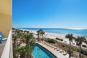 A poolside view with a beach and ocean in the background. - Calypso Resort by Best Beach Getaways (Panama City Beach)