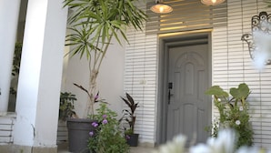 A porch with potted plants and a door. - Egypt 5 - STAR Cozy 3 BR Villa with Garden (First 6th of October)