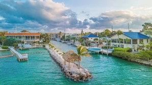 A marina with boats, a dock, and buildings with a tropical setting. - Vaca Cut Sunsets 5 bed 4 bath home with pool Gulf Views on Vaca Cut (Marathon)