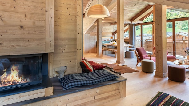 A spacious living area with a fireplace, wooden beams, and large windows. - New 8 Pax Apartment, Parking, Near Slopes (Les Belleville)