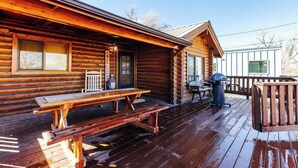 A wooden cabin with a porch, picnic table, grill, and a welcome sign. - Area 51 | Private Micro Pool-Resort | Pets OK (Hurricane)