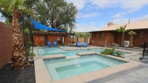 A backyard with a swimming pool, blue chairs, and a wooden house. - Area 51 | Private Micro Pool-Resort | Pets OK (Hurricane)