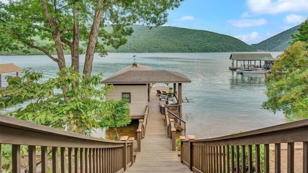 A wooden deck leading to a gazebo by a lake with a boat dock. - Hot Tub! Beautiful Mountain Views! Wifi!  Come Visit "Off the Bow"! (Huddleston)