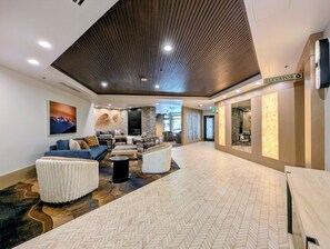 A modern lobby with a fireplace, seating area, and an elevator sign. - Cozy and Charming W/Fireplace, Hot Tubs, Garage (Keystone)