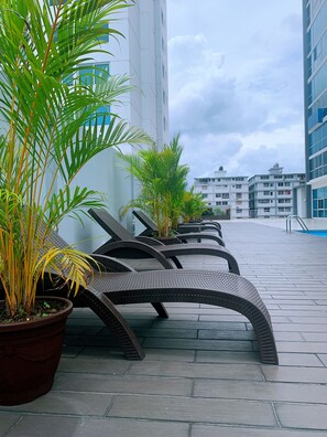Outdoor seating with potted plants, a tiled floor, and modern buildings in the background. - modern Loft in city centre with amazing views - in the Financial District - (Panamá)