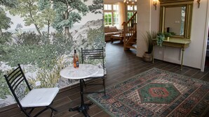A dining area with a table, chairs, and a decorative rug. - house 200 m2 4 bedrooms 4 bathrooms for 10 people in the valley of the kings (Azay-sur-Cher)