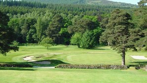 A golf course with a clear view of the fairway, sand bunkers, and a forested hill in the background. - Shieling Beag -  an apartment that sleeps 2 guests  in 1 bedroom (Banchory)
