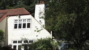 A two-story house with a white exterior, a red-tiled roof, and a chimney. - Shieling Beag -  an apartment that sleeps 2 guests  in 1 bedroom (Banchory)