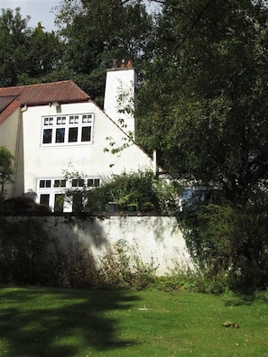 A two-story house with a white exterior, a red-tiled roof, and a chimney. - Shieling Beag -  an apartment that sleeps 2 guests  in 1 bedroom (Banchory)