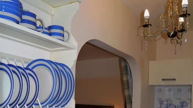 A compact kitchen with white cabinets, a sink, and a chandelier. - Shieling Beag -  an apartment that sleeps 2 guests  in 1 bedroom (Banchory)