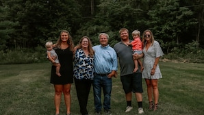A group of people standing on a grassy field with trees in the background. - Secluded, Quiet Tucked Away Cabin in Hocking Hills, Hot Tub, Relaxation (Logan)