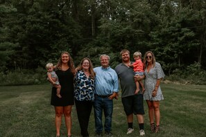 A group of people standing on a grassy field with trees in the background. - Secluded, Quiet Tucked Away Cabin in Hocking Hills, Hot Tub, Relaxation (Logan)