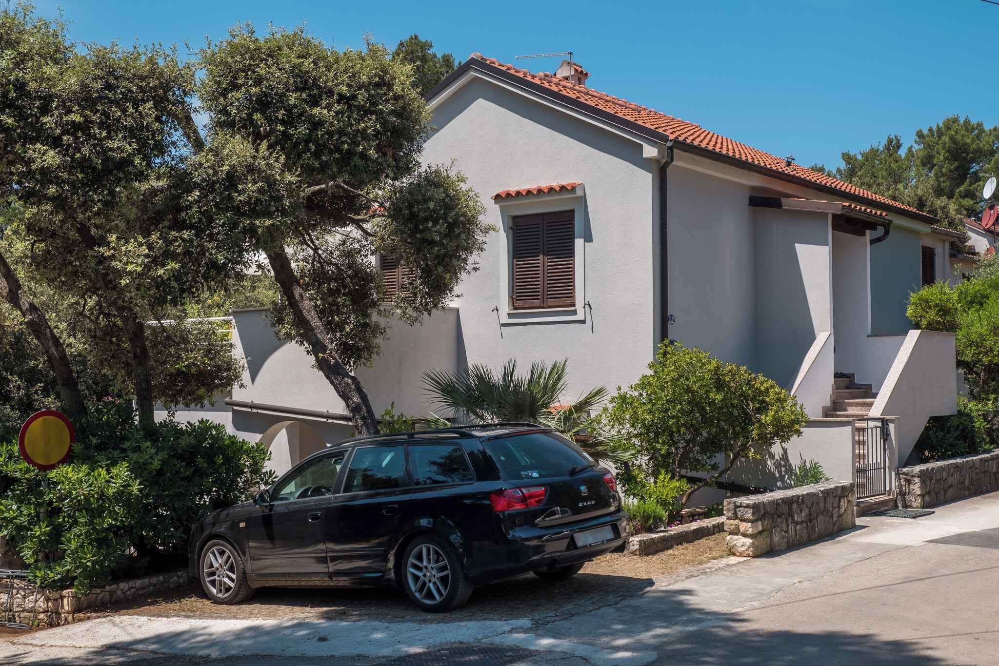A modern two-story house with a car parked in front.