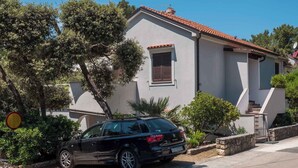A modern two-story house with a car parked in front.