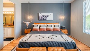 A bedroom with a large bed, a ceiling fan, a wall-mounted light fixture, and a window with blinds. - Stylish 3 Bedroom Sun City Grand Retreat w/ Resort Access in Surprise, Arizona (Surprise)